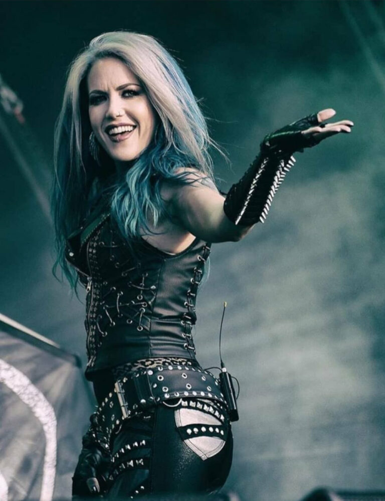A photo of Alissa White-Gluz gesturing to a live audience