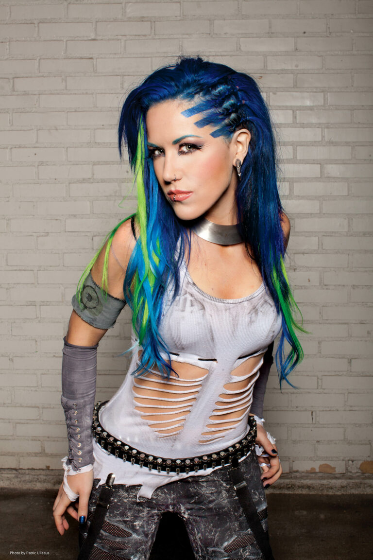 A picture of Alissa White-Gluz standing in front of a brick wall